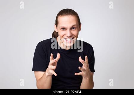 caucasian handsome man scheming something on gray background Stock Photo