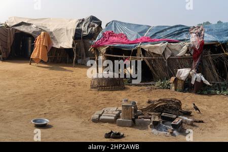 Damage to small hamlet following storm in Thar desert with belongings scattered and drying with hearth outdoors near Pushkar, Rajasthan, India. Stock Photo