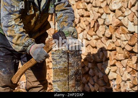 chopping firewood with a chopper close-up on a sunny day. High quality photo Stock Photo