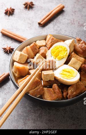 Five Spice Egg and Pork Belly Stew Asian food closeup in the bowl on the table. Vertical Stock Photo