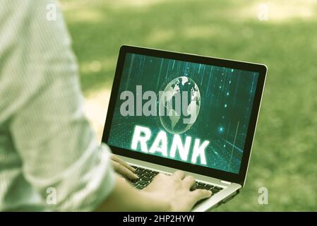 Writing displaying text Rank, Word for The showing or things that belong to a particular organization or group Woman Typing On Laptop In The Park Alon Stock Photo