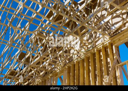Installation of wooden beams at construction in roof truss system the building Stock Photo