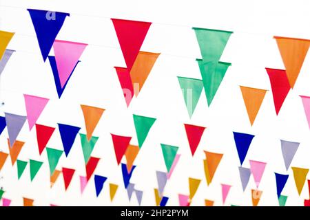 Colorful paper bunting party flags isolated on white background  . Carnival garland with flags. Decorative colorful party pennants for birthday celebr Stock Photo