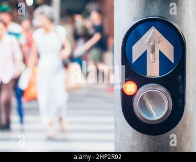 Pedestrian traffic light crossing push button controller in Bangkok Thailand . Car accident campaign idea background.Blurred people across the road in Stock Photo