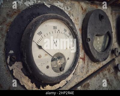Close up shot of a rusty old large voltmeter. Stock Photo