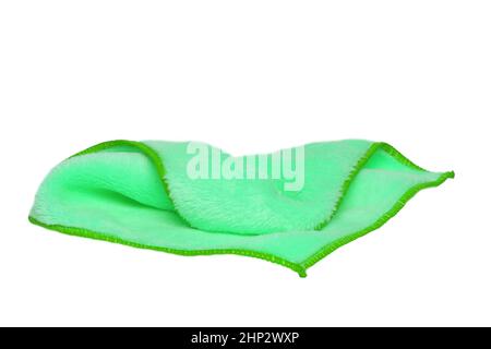 Household cleanliness and hygiene. Close-up of a green cleaning cloth isolated on a white background. Microfiber cleaning cloth. Macro. Stock Photo