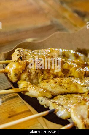Chicken skewers Thai night market street food in Huai Khwang Bangkok Thailand. Stock Photo