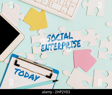Handwriting text Social Enterprise, Business idea Business that makes money in a socially responsible way Building An Unfinished White Jigsaw Pattern Stock Photo