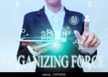 Conceptual caption Organizing Force, Business idea being United powerful group to do certain actions Woman In Suit Holding Tablet Pointing Finger On F Stock Photo