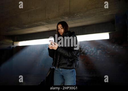 Scared young woman being harassed by cyber bullies Stock Photo