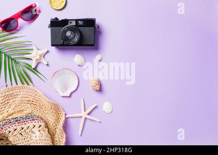 Top view flat lay mockup of camera films, airplane, sunglasses, starfish beach traveler accessories isolated on a purple background with copy space, B Stock Photo