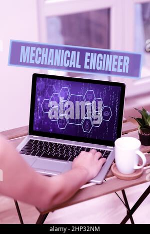Conceptual display Mechanical Engineer, Word Written on Applied Engineering Discipline for Mechanical System Hand Busy Typing On Laptop Beside Coffe M Stock Photo