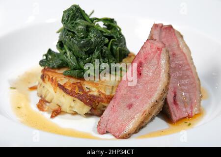 A lamb loin with spinach and potato rosti Stock Photo