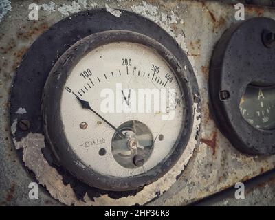 Close up shot of a rusty old large voltmeter. Stock Photo