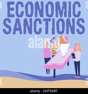 Sign displaying Economic Sanctions, Word for Penalty Punishment levied on another country Trade war Colleagues Drawing Standing Beside Table Projectio Stock Photo