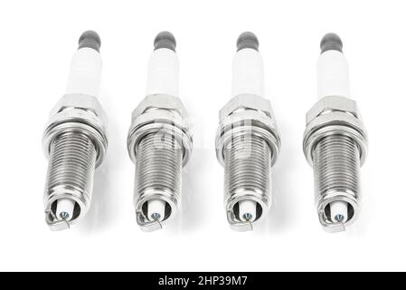 Four iridium spark plugs in a row isolated on white background with clipping path Stock Photo