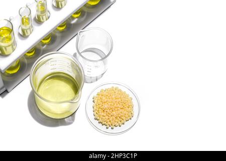 Nickle chloride liquid in test tube, Candelilla Wax in Chemical Watch Glass and alcohol in beaker place on white laboratory table. Stock Photo
