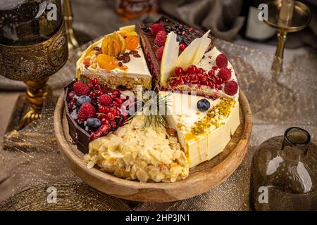 Different slices of various cakes, making a single whole torte Stock Photo