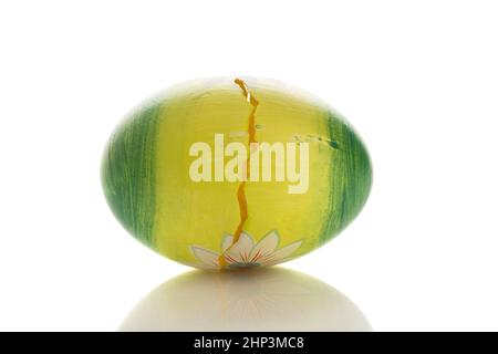 Green painted easter egg with a crack in it Stock Photo