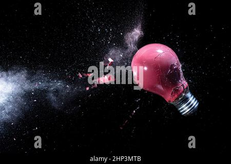 explosion of a red light bulb on black. high speed photography. Stock Photo
