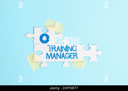 Text sign showing Training Manager, Business concept giving needed skills for high positions improvement Building An Unfinished White Jigsaw Pattern P Stock Photo