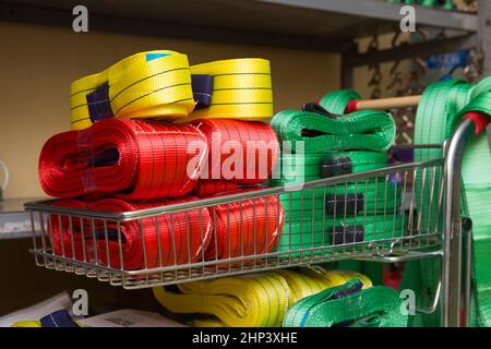 Industrial sewing machine sews a webbing sling. Manufacture of textile slings and tie straps Stock Photo