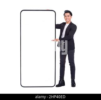 young man standing and showing big Smartphone With Blank White Screen Stock Photo