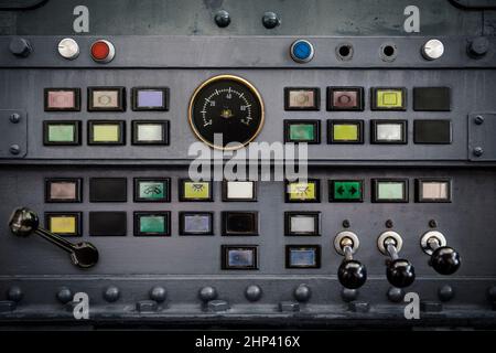 Old switches, buttons, and levers on a metal panel as a background for industry. Stock Photo