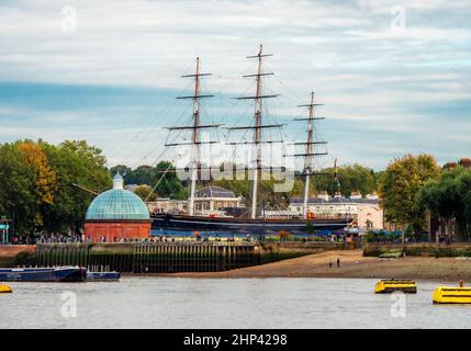 London, England, UK - October 17, 2019: View from the River Thames of the famous Cutty Sark historical ship and Greenwich Pier in fall season Stock Photo