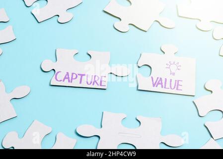Text sign showing Capture Value, Business approach Customer Relationship Satisfy Needs Brand Strength Retention Building An Unfinished White Jigsaw Pa Stock Photo
