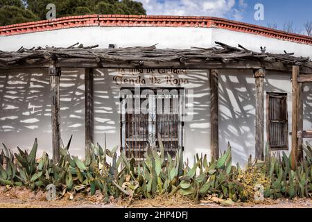 Cactus sits in front of an old building and its shadows on a corner of the San Elizario Historic District southeast of El Paso, Texas. Stock Photo