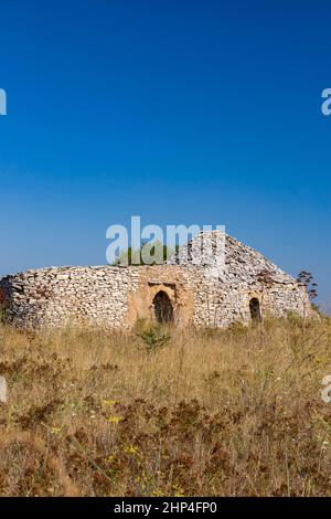 Trulli, typical houses near Castel del Monte, Apulia region, Italy Stock Photo