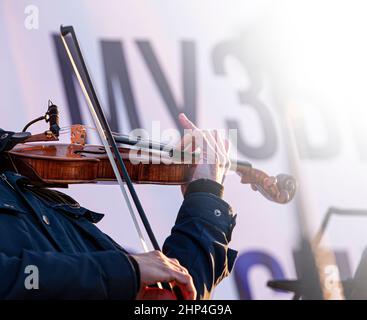 The street musician violin plays music outdoors Stock Photo