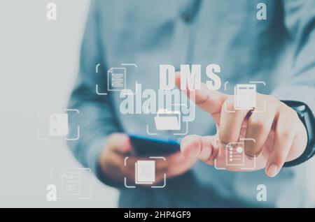 DMS Integrated Document Management System concept Online document database and digital file archiving software.man hands touch  virtual screen icon bu Stock Photo