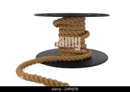Braided natural jute rope wrapped on the reel isolated on white background Stock Photo