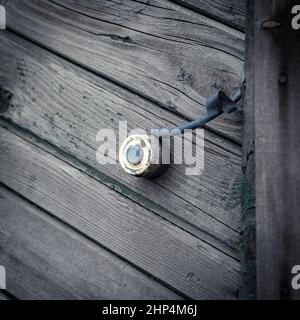 an old doorbell button on the wooden wall realistic Stock Photo