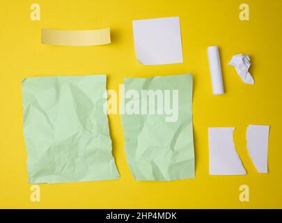 various torn pieces of paper on yellow background, set Stock Photo