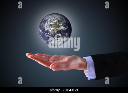 business hand holding globe(Collage images from www.nasa.gov) Stock Photo