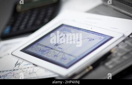 Closeup picture of a keyboard with a phone and tablet lying above it Stock Photo