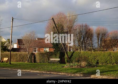 Ashford, Kent, UK. 18 Feb, 2022. UK Weather: A telegraph pole hangs precariously as Storm Eunice passes through the Kent countryside. Hamstreet in Ashford, Kent. Photo Credit: Paul Lawrenson-PAL News /Alamy Live News Stock Photo