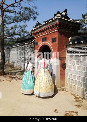 Beautiful girls dressed hanbok, Korean traditional dress, South Korea. Back view. Tourism, travel. Stock Photo