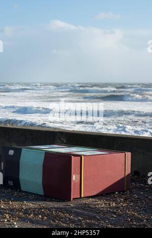 Brighton & Hove, East Sussex. 18th February 2022, 2022. UK Weather. Storm Eunice starts to ease, but leaves pebbles and waste bins strewn all over the Hove seafront promenade. The Met Office has issued a red warning due to ‘hurricane-style winds of up to 90mph’. Credit: Francesca Moore/Alamy Live News Stock Photo