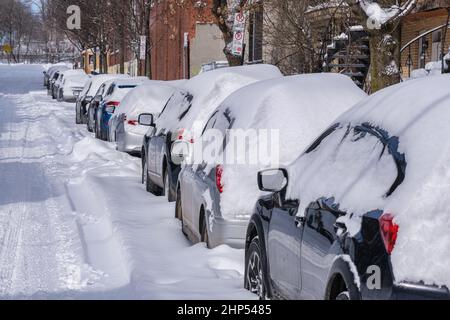 Montreal, Canada - 18 February 2022: Cars covered with snow after snow storm. Stock Photo