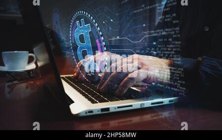 Bitcoin blockchain crypto currency and digital money symbol and man typing computer keyboard. Hands on laptop. Network, cyber technology and backgroun Stock Photo