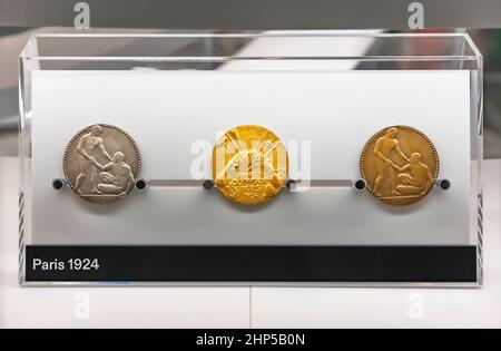tokyo, japan - august 10 2021: Gold,silver and bronze medals of Paris 1924 Summer Olympics Games depicting fraternizing athletes and sports equipment Stock Photo