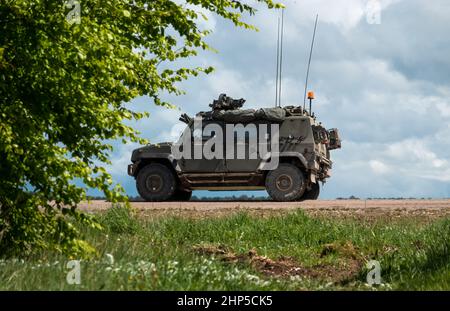 British army Panther 4x4 command and liaison vehicle in action on Salisbury Plain military training area, Wiltshire UK Stock Photo