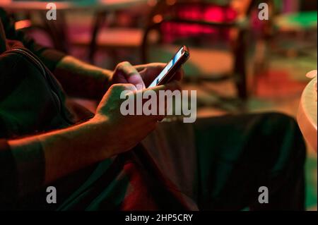 Man texting on the phone in the club Stock Photo