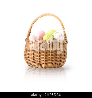 Wicker basket with easter colorful eggs isolated on white background. Spring easter composition. Stock Photo