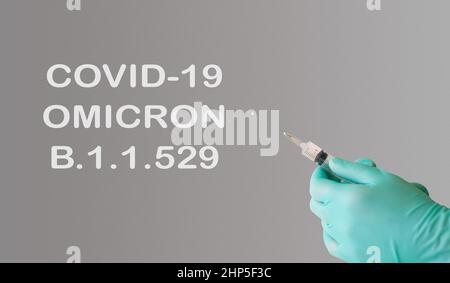 A doctor holds a vaccine against a new variant of omicron covid-19. Vaccine against the South African variant of the coronavirus covid-19 omicron B.1 Stock Photo