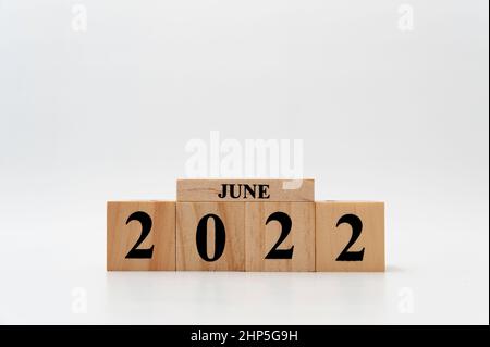 June 2022 written on wooden blocks isolated on white background with copy space. Stock Photo